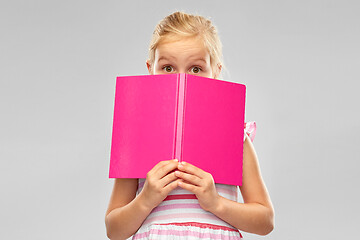 Image showing little girl hiding over book