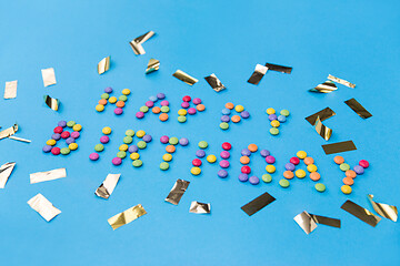 Image showing happy birthday of candies and confetti on blue