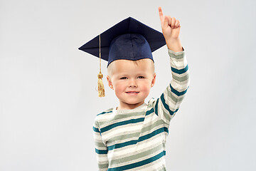 Image showing little boy in mortar board pointing finger up