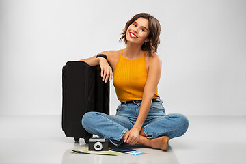 Image showing woman with travel bag, air ticket, map and camera