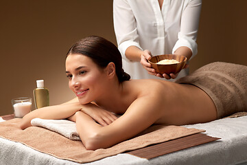 Image showing woman and cosmetologist with mask in bowl at spa