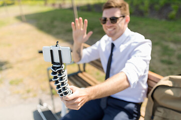 Image showing businessman recording video blog by smartphone