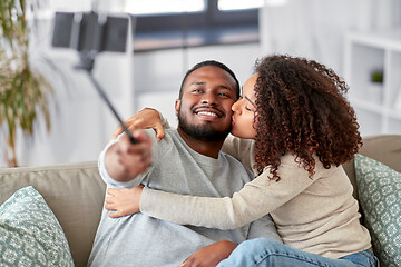 Image showing couple taking picture by selfie stick at home