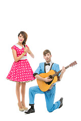 Image showing doll looking boy and girl with guitar