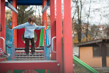 Image showing cute little boy having fun in playground