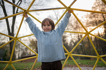 Image showing cute little boy having fun in playground