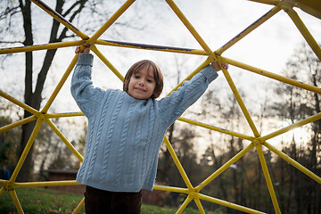 Image showing cute little boy having fun in playground