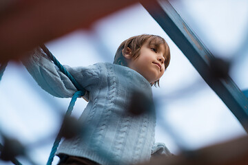 Image showing cute little boy having fun in playground