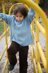 Image showing cute little boy having fun in playground