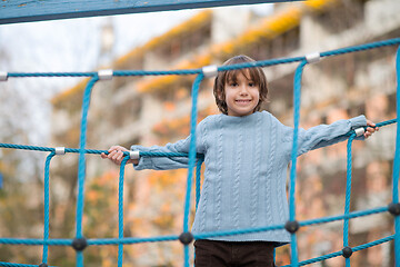 Image showing cute little boy having fun in playground