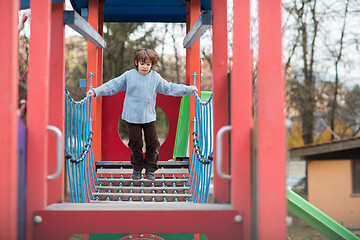 Image showing cute little boy having fun in playground