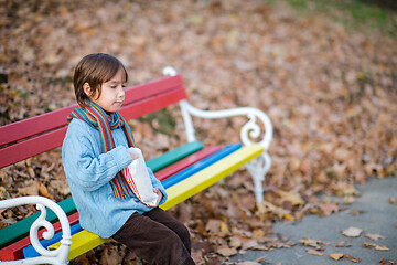 Image showing cute little boy in park eating popcorn