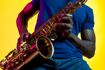 Image showing Young african-american jazz musician playing the saxophone