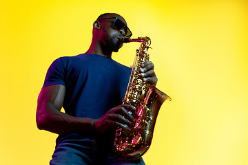 Image showing Young african-american jazz musician playing the saxophone