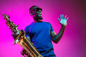 Image showing Young african-american jazz musician playing the saxophone