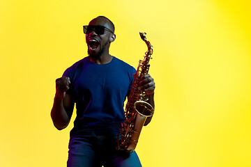 Image showing Young african-american jazz musician playing the saxophone