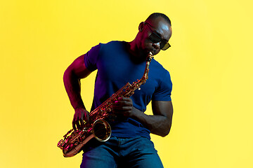 Image showing Young african-american jazz musician playing the saxophone