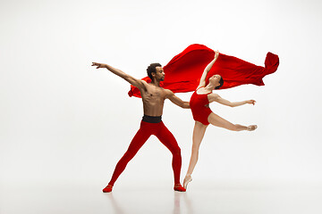 Image showing Young graceful couple of ballet dancers dancing on white studio background