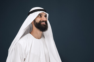 Image showing Arabian saudi businessman on dark blue studio background