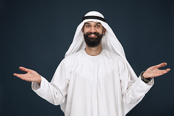 Image showing Arabian saudi businessman on dark blue studio background