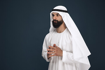 Image showing Arabian saudi businessman on dark blue studio background