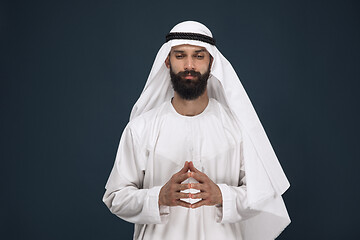 Image showing Arabian saudi businessman on dark blue studio background