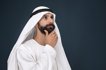 Image showing Arabian saudi businessman on dark blue studio background