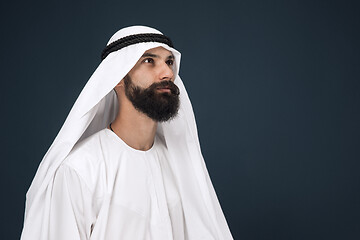 Image showing Arabian saudi businessman on dark blue studio background