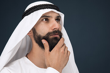 Image showing Arabian saudi businessman on dark blue studio background