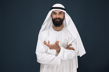 Image showing Arabian saudi businessman on dark blue studio background