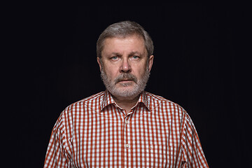 Image showing Close up portrait of senior man isolated on black studio background