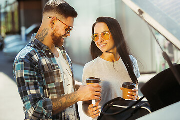 Image showing Young couple preparing for vacation trip on the car in sunny day