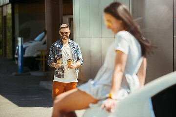 Image showing Young couple preparing for vacation trip on the car in sunny day