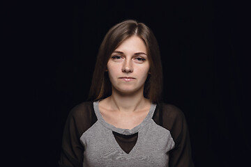 Image showing Close up portrait of young woman isolated on black studio background