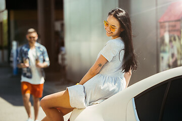 Image showing Young couple preparing for vacation trip on the car in sunny day