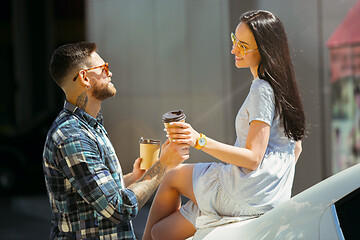 Image showing Young couple preparing for vacation trip on the car in sunny day