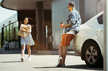 Image showing Young couple preparing for vacation trip on the car in sunny day