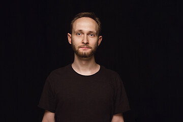 Image showing Close up portrait of young man isolated on black studio background