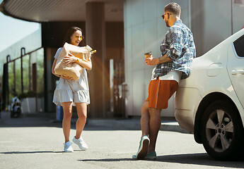 Image showing Young couple preparing for vacation trip on the car in sunny day