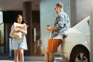 Image showing Young couple preparing for vacation trip on the car in sunny day