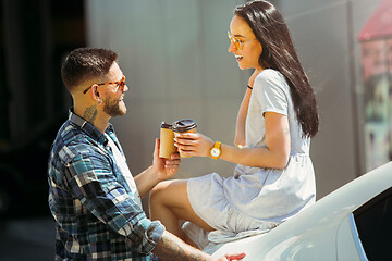 Image showing Young couple preparing for vacation trip on the car in sunny day