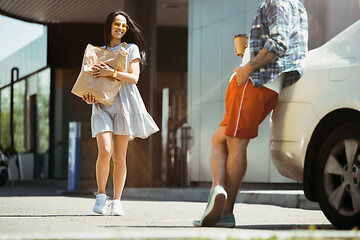 Image showing Young couple preparing for vacation trip on the car in sunny day