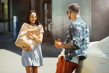 Image showing Young couple preparing for vacation trip on the car in sunny day