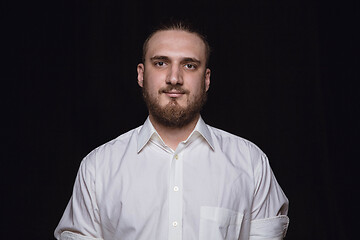 Image showing Close up portrait of young man isolated on black studio background