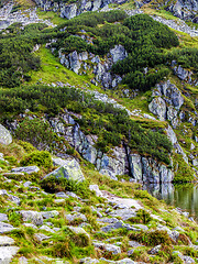 Image showing Mountain slope with small lake at botom