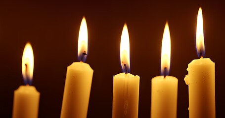 Image showing Candles glowing against dark background