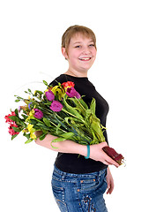 Image showing Happy smiling young girl presenting flowers 