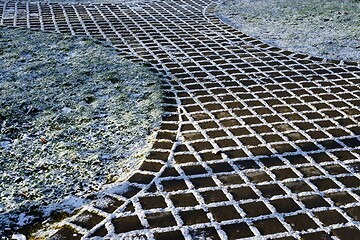 Image showing first snow-covered cobblestone path 