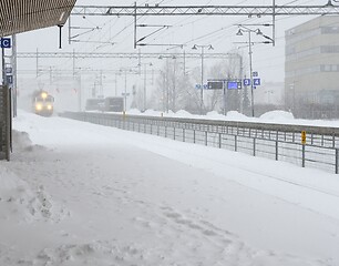 Image showing the train arrives at the station during a blizzard