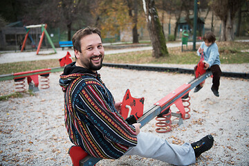 Image showing father and  child having fun together  in park